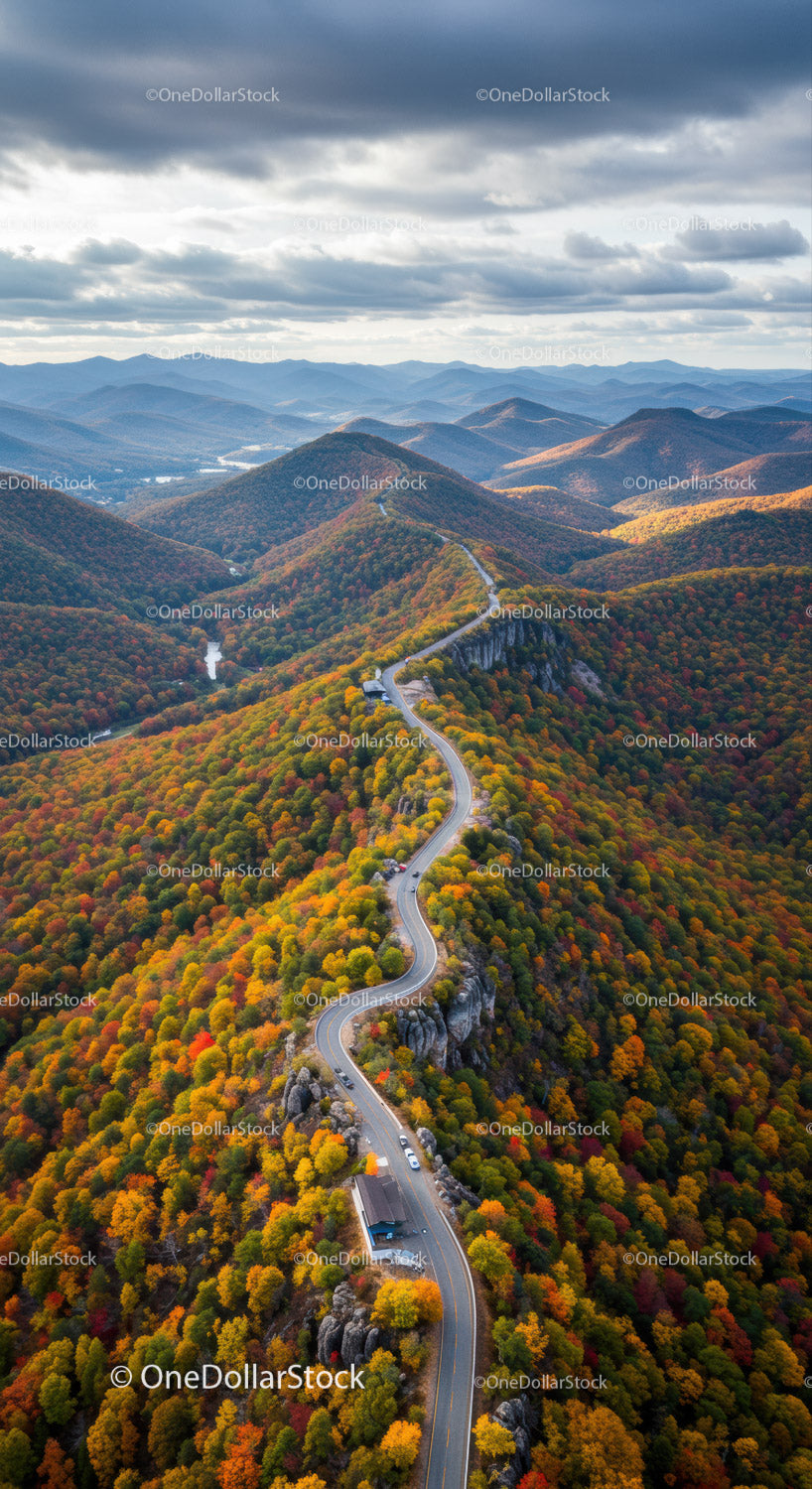Majestic Mountain Landscape with Winding Road and Vibrant Fall Foliage