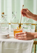 Elegant Amber Cocktail with Citrus Garnish on Stylish Table