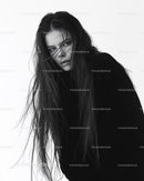 Black and White Portrait of a Woman with Long Wet Hair and Intense Gaze