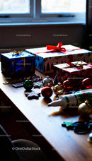 Christmas gift wrapping with festive decorations on table