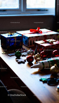 Christmas gift wrapping with festive decorations on table