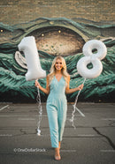 Smiling young woman celebrating eighteenth birthday outdoors
