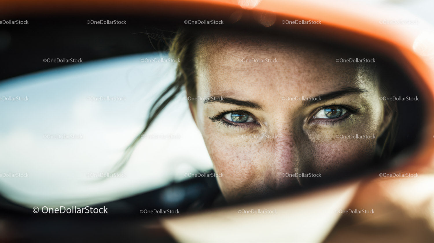 Close-up of a Woman's Face with Blue Eyes and Freckles in Reflection