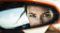 Close-up of a Woman's Face with Blue Eyes and Freckles in Reflection