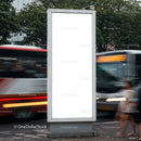 Blank vertical billboard on busy urban street corner