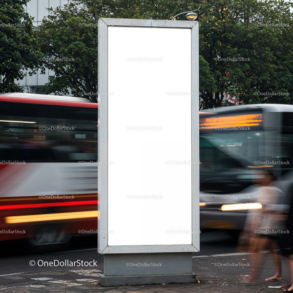 Blank vertical billboard on busy urban street corner JPG Mockup Image