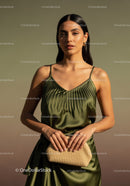 Elegant Woman in Satin Green Dress with Beige Clutch Outdoor