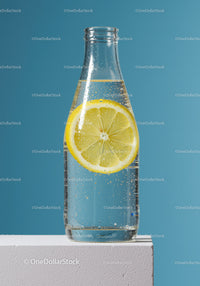 Lemon Slice in Clear Sparkling Water Bottle on Blue Background
