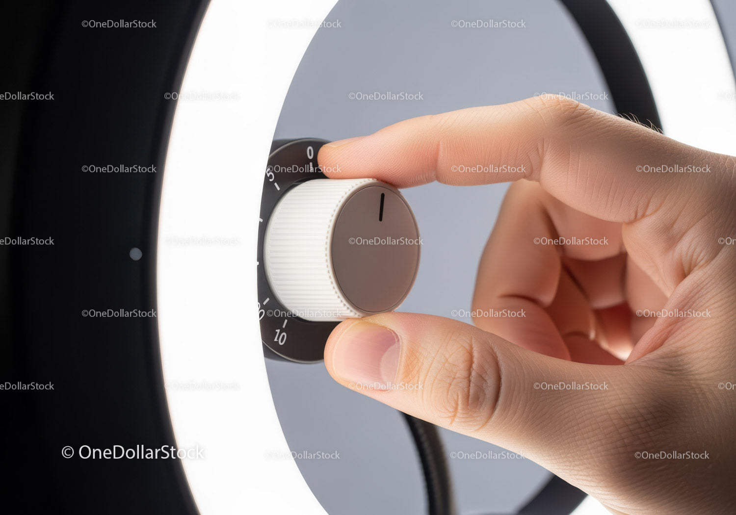Close-up of Hand Adjusting Modern Home Thermostat