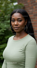 Confident young woman posing outdoors with calm expression