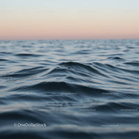 Calm Ocean Waves at Sunset with Gentle Ripples and Serene Horizon