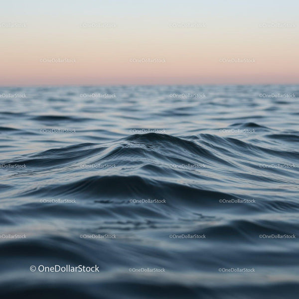 Calm Ocean Waves at Sunset with Gentle Ripples and Serene Horizon