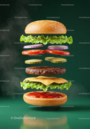 Deconstructed cheeseburger ingredients floating on green background