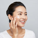 Young Woman Applying Skincare Cream for Healthy Glowing Skin