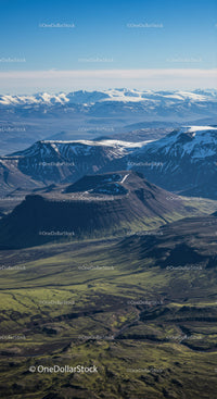Majestic Snow-Capped Mountains with Green Valleys and Rugged Terrain