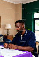 Focused man reviewing documents at home desk