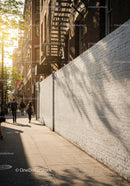 Sunlit City Street with Brick Buildings and Pedestrians