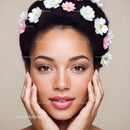 Young Woman with Freckles Wearing Flower Headband in Soft Light
