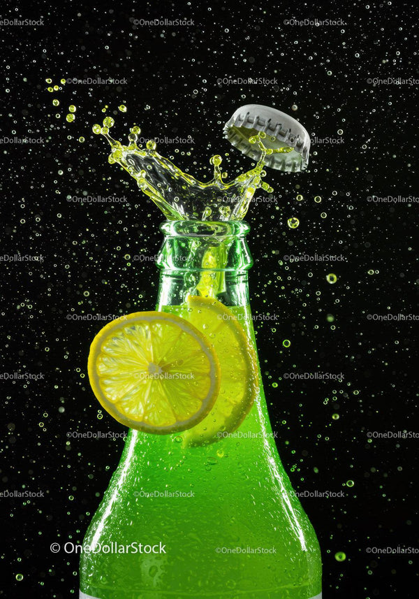 Refreshing green soda bottle with lemon splash
