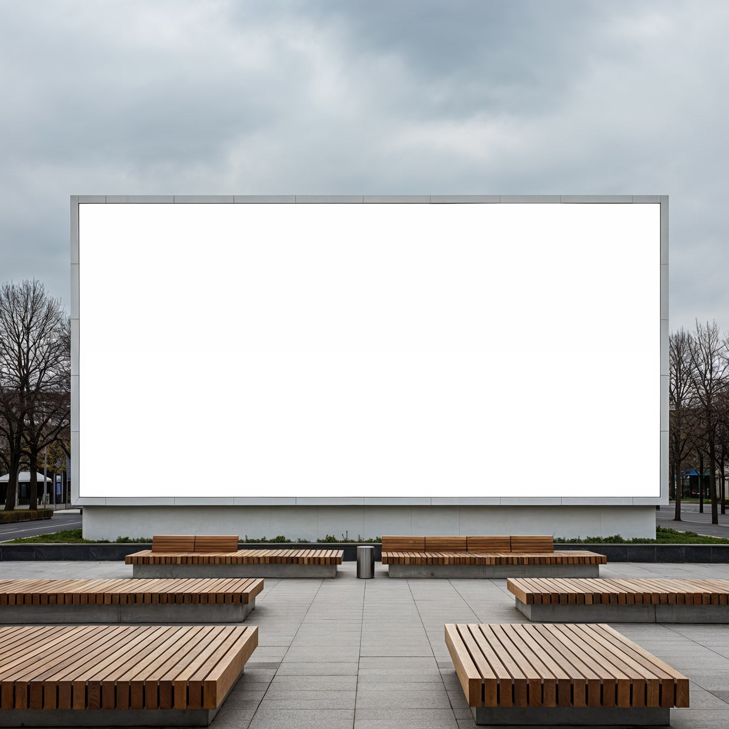 Modern urban plaza with empty white billboard and benches