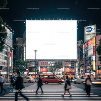Busy city crosswalk with illuminated billboard at night