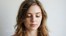Beautiful Young Woman with Soft Makeup and Wavy Hair