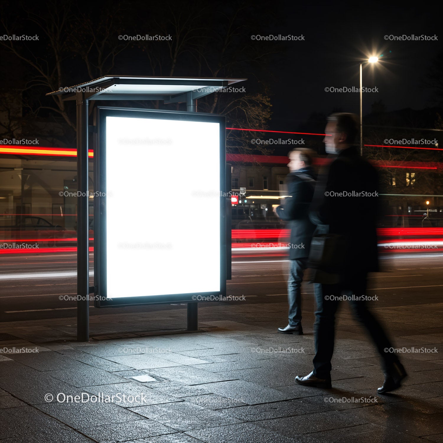 Nighttime urban scene with illuminated billboard and pedestrians