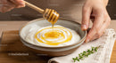 Drizzling Honey Over Creamy Greek Yogurt in a Rustic Bowl