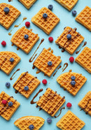 Delicious waffles with berries and caramel drizzle