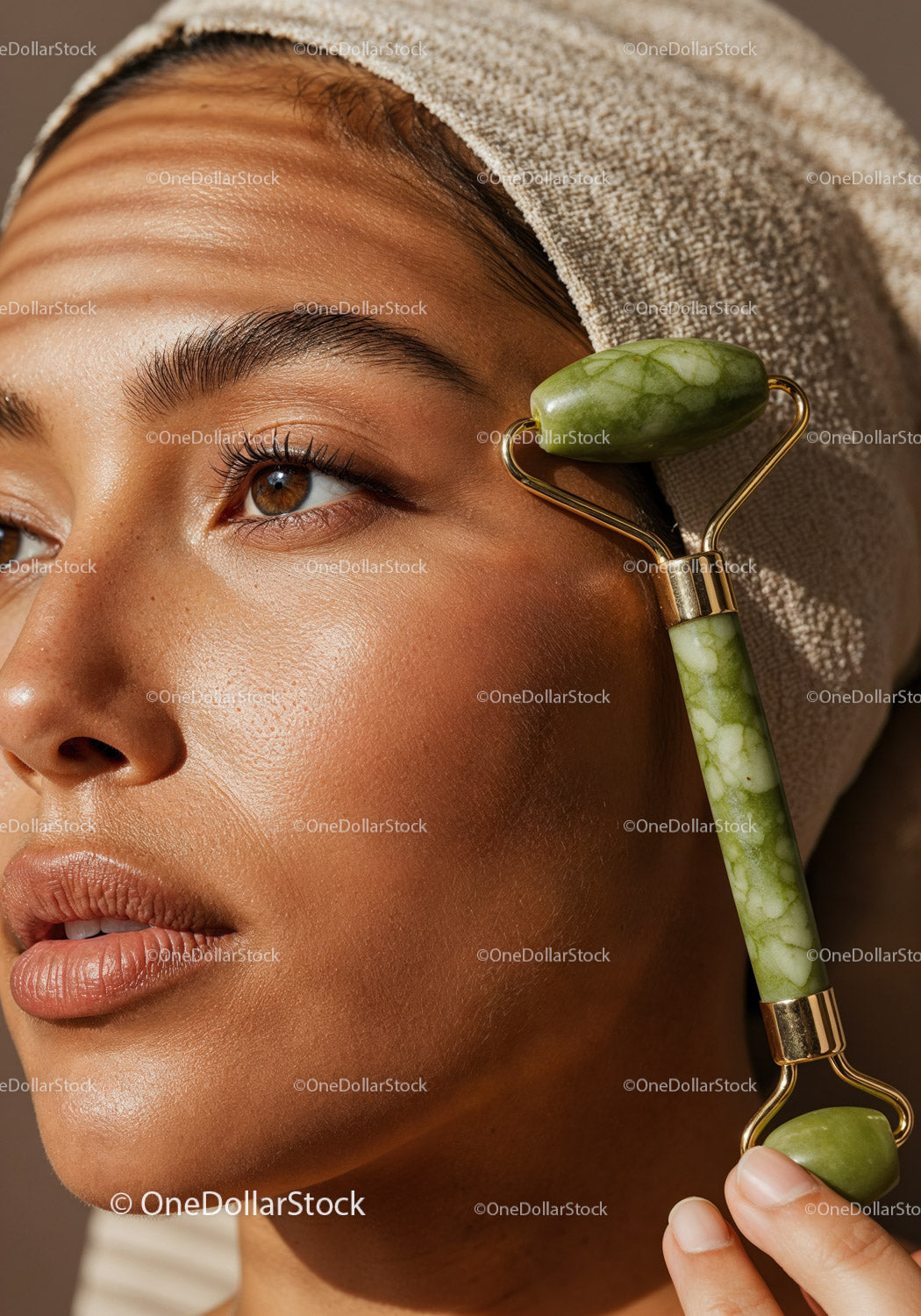 Close-Up of a Woman Using Jade Roller for Facial Massage and Skin Rejuvenation
