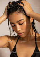 Young Woman with Wet Hair and Glowing Skin in Close-Up Portrait