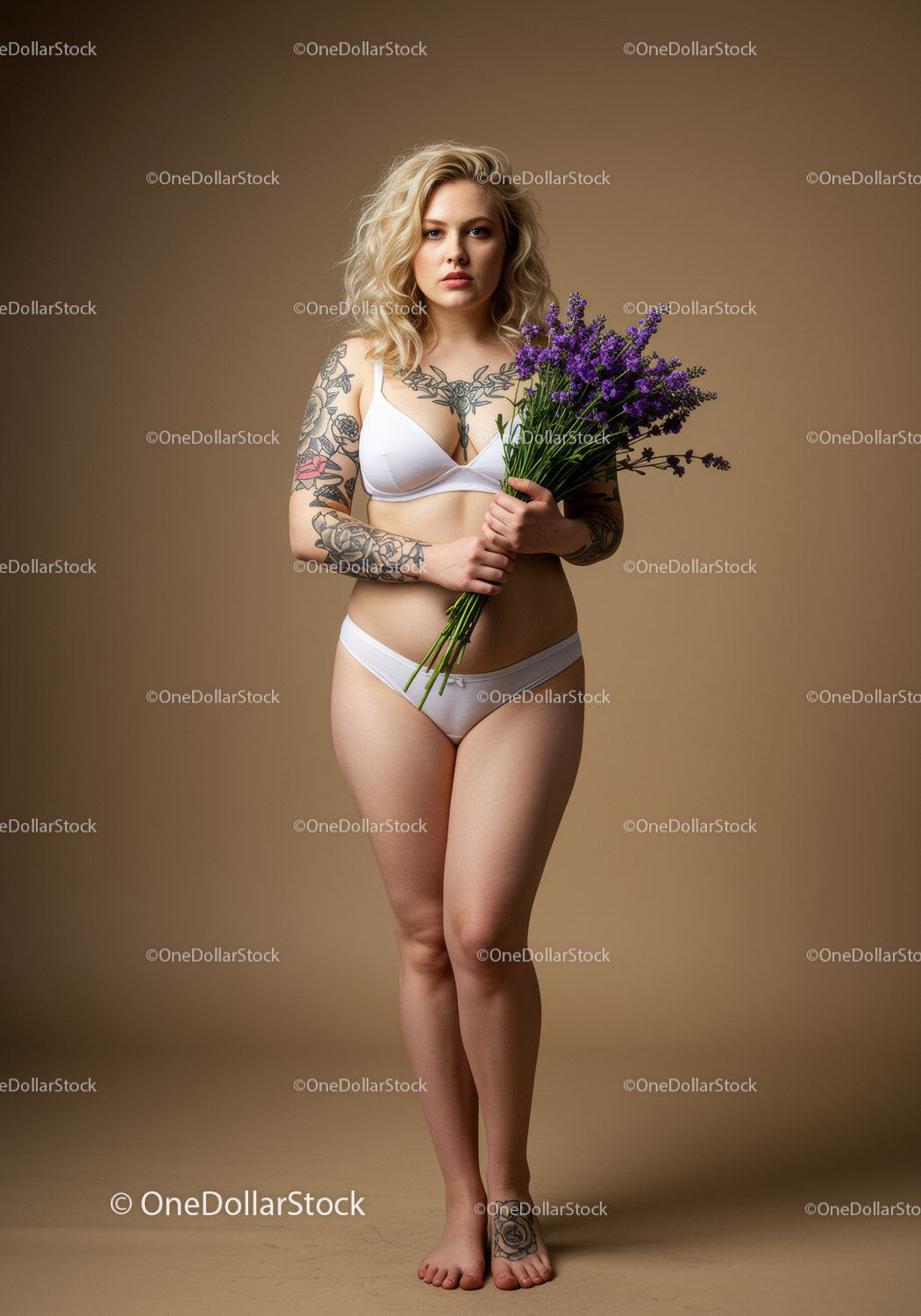 Tattooed Woman Holding Lavender Flowers in Stylish Lingerie