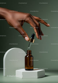 Elegant Hand with Dropper and Amber Bottle for Skincare and Beauty