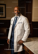 Professional Male Doctor in White Coat Standing in Medical Office