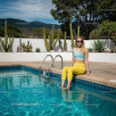 Trendy Young Woman Relaxing by the Vibrant Swimming Pool