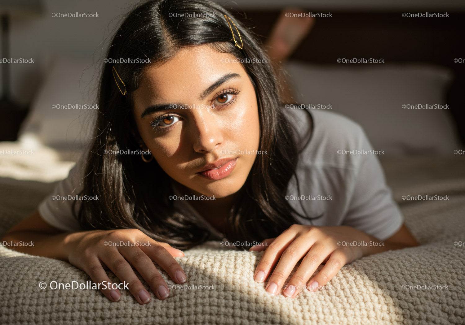 Portrait of a Young Woman Relaxing on a Beige Sofa with Warm Lighting