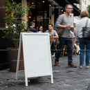 Blank Sidewalk Sign Near Busy Outdoor Café Seating