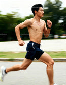 Athletic man sprinting outdoors on a summer day
