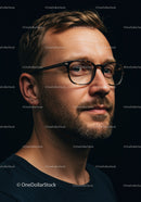 Thoughtful man with glasses looking to the side