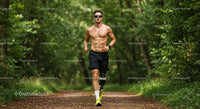 Male Runner with Prosthetic Leg Running Through Foggy Forest Trail