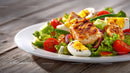 Colorful Vegetable and Grilled Chicken Salad in a White Plate
