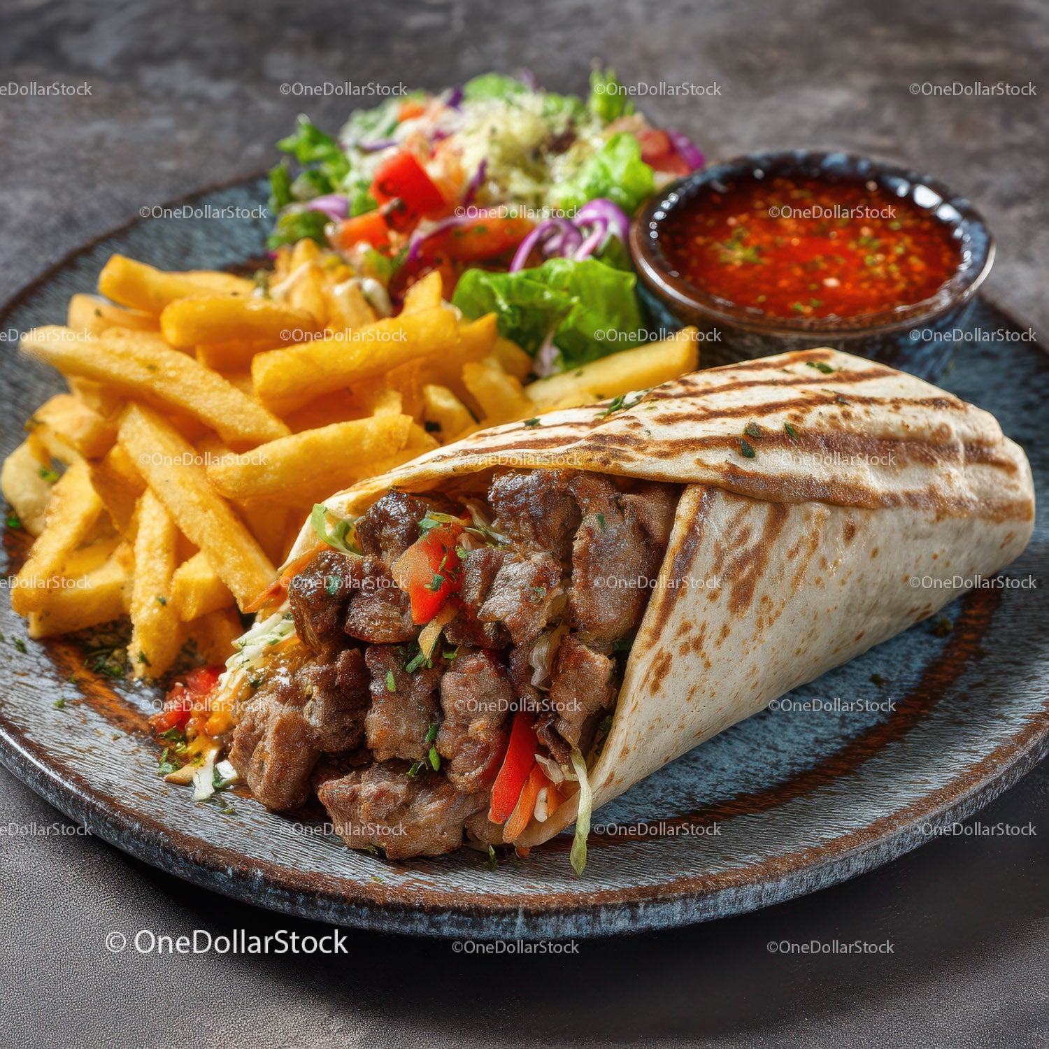 Beef Burrito with French Fries and Fresh Salad in a Black Plate
