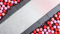 Colorful macarons arranged on black and white stone slabs