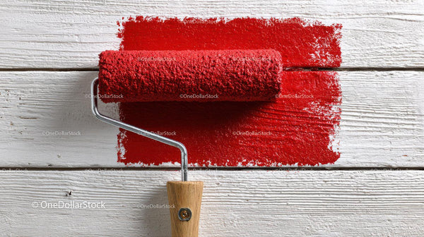 Red Paint Roller on White Wooden Surface for Interior Decor