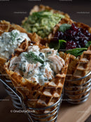 Delicious Chicken Waffles with Creamy Dill Sauce on Wooden Table