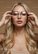 Elegant Woman with Blonde Hair and Round Glasses in Neutral Studio Setting