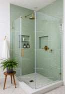 Modern bathroom with glass shower and green tiles