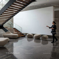 Modern minimalist lobby with wooden stairs and seating