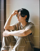 Young man sitting thoughtfully by the window