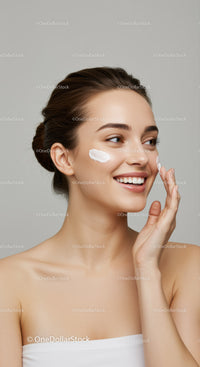 Young Woman Applying Skincare Cream with Bright and Clear Skin
